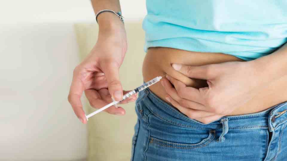 Stomach weight loss injection being administered