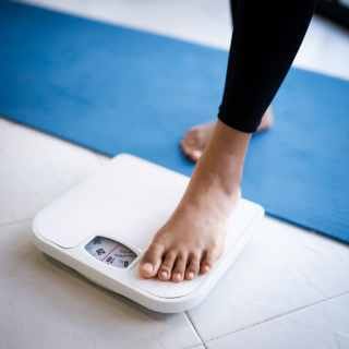 Woman stepping on scales