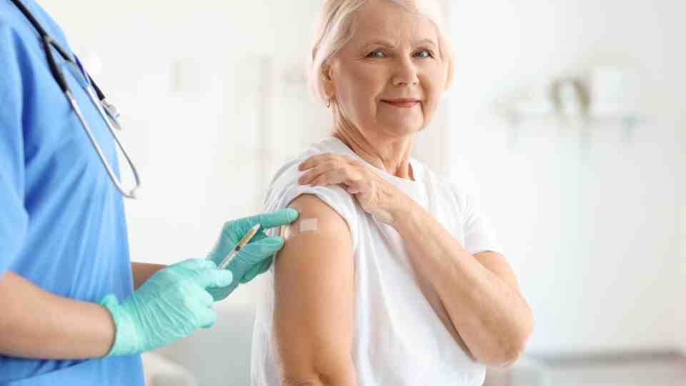 Happy woman getting a travel vaccine
