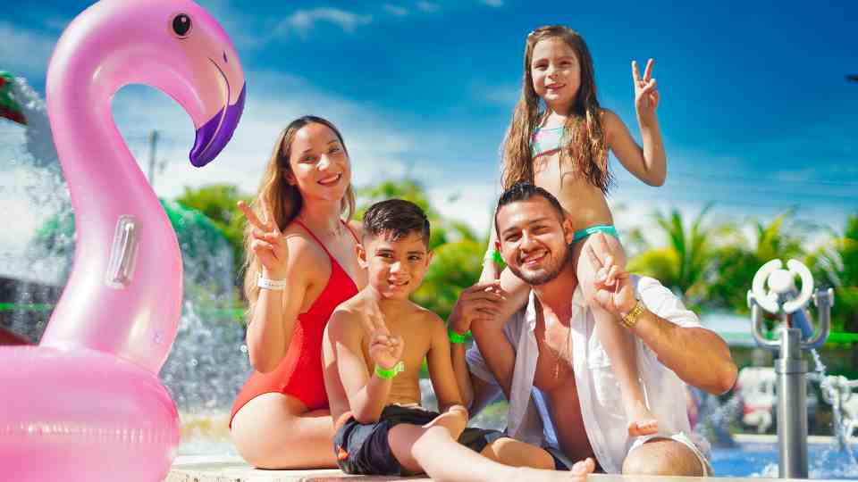 Family enjoying a pool sunny summer holiday